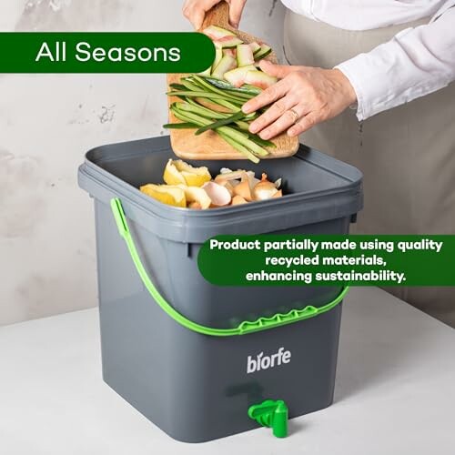 Person adding vegetable scraps to a gray compost bin with green handle.