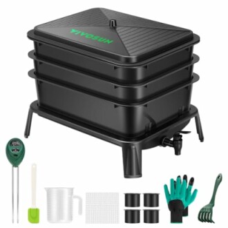 Black worm composting bin with tools and accessories.