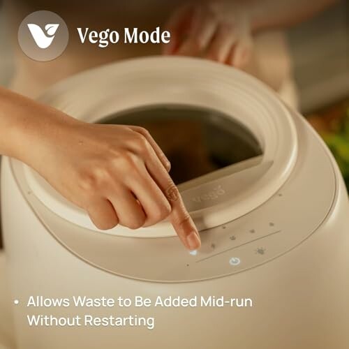 Person using Vego Mode compost machine with waste addition feature