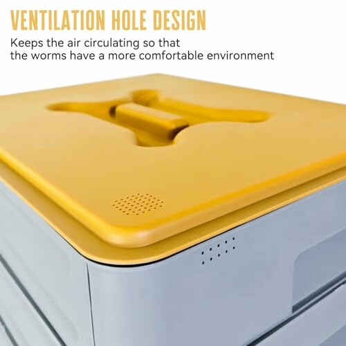 Close-up of a worm bin with a yellow lid showing ventilation holes.